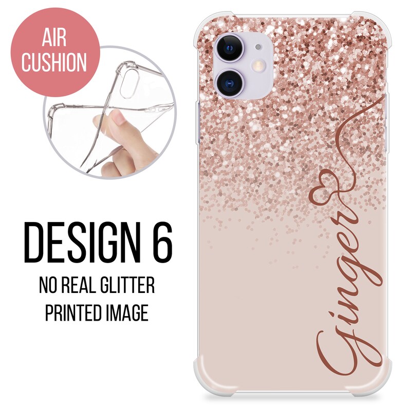 May include: A clear phone case with a pink and rose gold glitter design. The case has a raised edge around the camera lens and a printed image of the word "Ginger" in a cursive font.