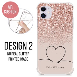 May include: A clear phone case with a rose gold glitter design and a black outline of a heart with the text "Edie Whitney" at the bottom. The case has an air cushion bumper for protection.
