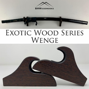 May include: A dark brown wooden sword stand with a wave design. The stand is made of Wenge wood and is part of the Exotic Wood Series. The stand is designed to hold a katana sword.