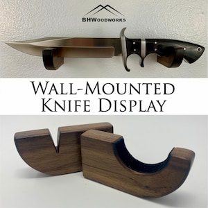 May include: Wall-mounted knife display made of dark wood with a black felt lining. The display is designed to hold a knife horizontally. The text "WALL-MOUNTED KNIFE DISPLAY" is printed in white on a black background.