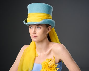 Cylinder Hat with a gorgeous silk bow. Sky blue top hat with a bright yellow silk bow. horse race millinery headwear. Royal Ascot blue Hat