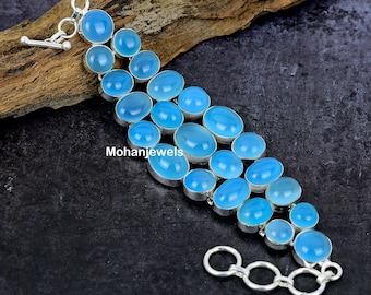 May include: A silver bracelet featuring a light blue gemstone design. The bracelet has multiple oval-shaped gemstones arranged in a cascading pattern. The bracelet has a lobster clasp fastening and a chain link extension.