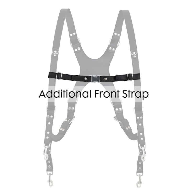 May include: A black leather harness with silver-tone hardware and an additional front strap. The text "Additional Front Strap" is printed in black below the strap.