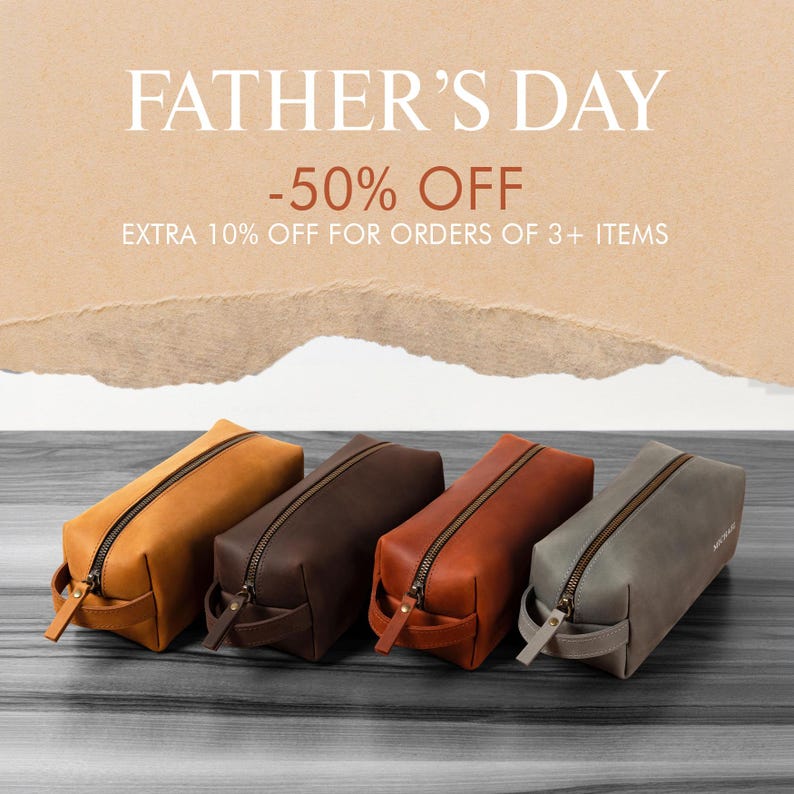 May include: Four leather toiletry bags in shades of tan, brown, and gray are displayed on a wooden surface. Each bag has a zipper closure and a small handle. The text "FATHER'S DAY -50% OFF" is at the top of the image.