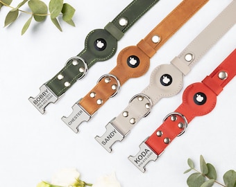 May include: Four leather dog collars in green, tan, beige, and red. Each collar has a silver buckle with a name engraved on it. The collars also feature a circular tag with a black and white design.