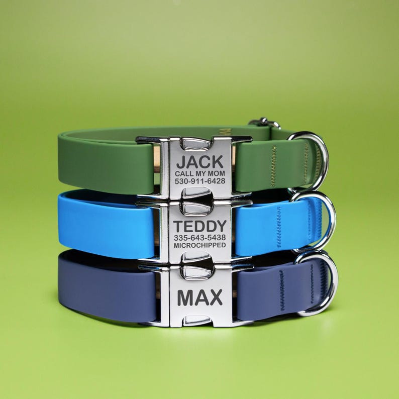 May include: Three personalized dog collars stacked on top of each other. The top collar is green, the middle is blue, and the bottom is navy. Each collar has a silver buckle with a name and phone number. The top collar says "JACK" and "CALL MY MOM".