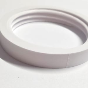 May include: White plastic ring with three ridges on the inside. The ring is smooth and has a slightly rounded edge.