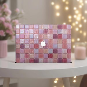 Op de afbeelding: Een laptophoes met een mozaïekpatroon in roze, lila en wit. De hoes heeft een glanzende afwerking en een wit Apple-logo. Het ontwerp bestaat uit kleine, vierkante tegels.