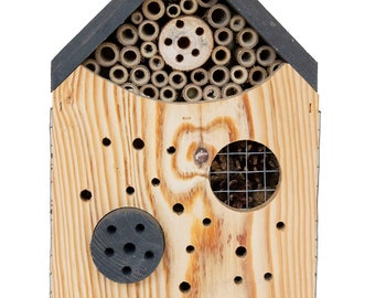 May include: A wooden insect house with a black roof and multiple compartments for different types of insects. The house has a variety of holes and compartments, including a section with bamboo tubes, a section with a wire mesh, and a section with a solid wooden panel.