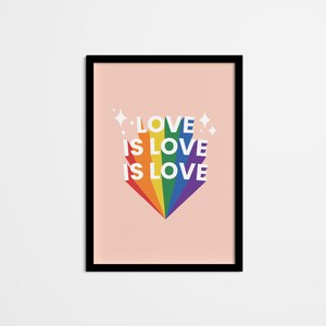 May include: A framed print with a pink background and a rainbow design. The rainbow is shaped like a heart and has the text "LOVE IS LOVE IS LOVE" in white letters.