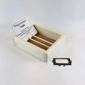 May include: A white wooden soap dish with three dividers and a brass label holder. The dish has a business card inside that reads "Whippersnapper Creates" with contact information for the business.