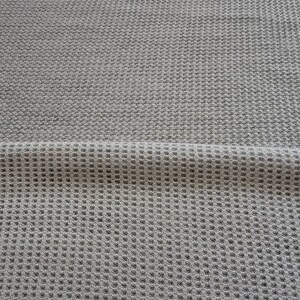 May include: A close-up of a gray waffle knit fabric. The fabric has a textured surface and a subtle sheen.