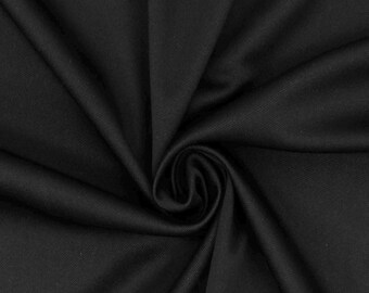 May include: Close-up of a black fabric with a swirling pattern. The fabric is smooth and appears to be a solid color. The folds create shadows and highlights, adding depth to the image. The fabric is likely used for clothing or home decor.