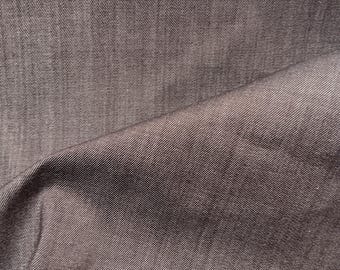 May include: Close-up of a dark gray fabric with a subtle diagonal weave pattern. The fabric is smooth and has a slight sheen.