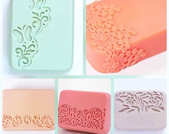 May include: Four rectangular soap bars with different floral and butterfly designs. The soap bars are in various colors, including light green, peach, light pink, and light purple.