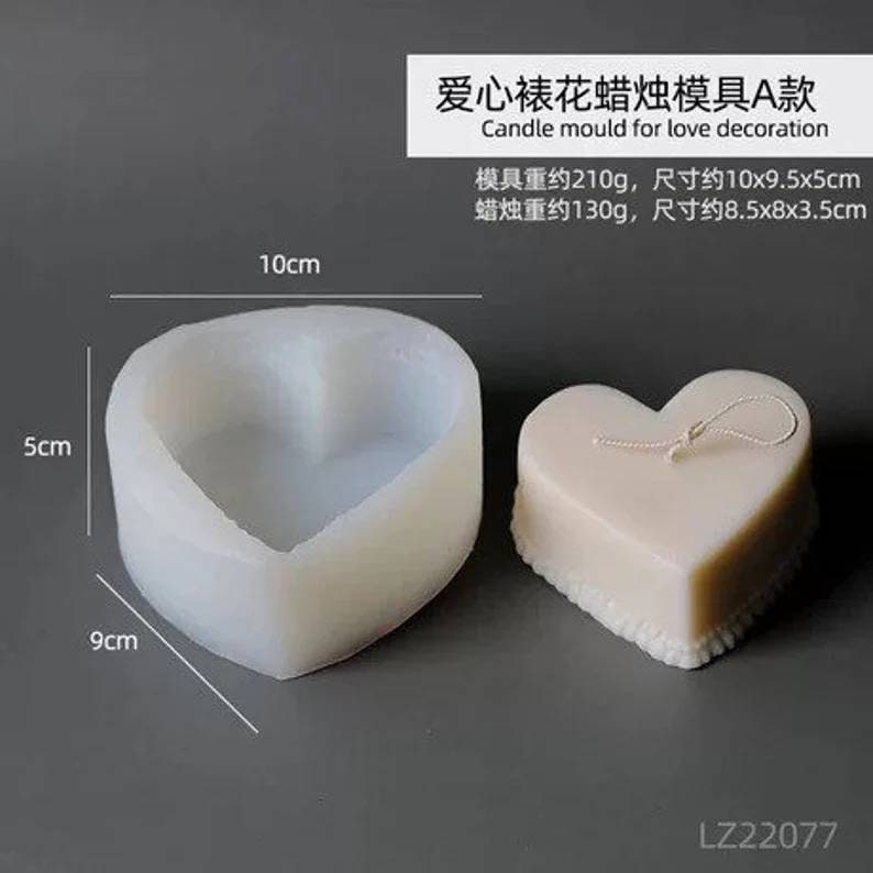 May include: A white silicone heart-shaped mold for making candles. The mold is 10 inches wide, 9.5 inches long, and 5 inches tall. A finished candle is shown next to the mold.