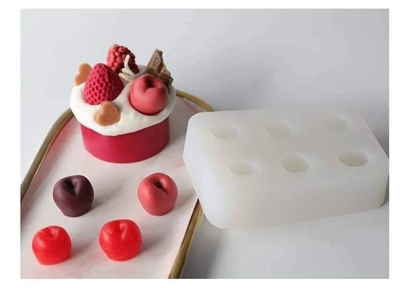 May include: A white silicone mold with six round cavities for making small cakes or desserts. The mold is shown next to a finished cake decorated with red and white fondant, chocolate, and a strawberry.