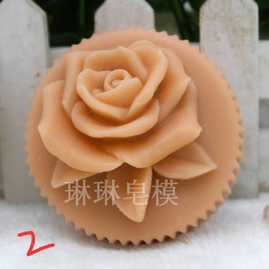May include: A light brown rose-shaped soap with a scalloped edge. The soap has a detailed rose design and the text "珠珠皂模" is visible in the center.