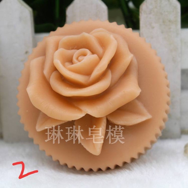 May include: A light brown rose-shaped soap with a scalloped edge. The soap has a detailed rose design and the text "珠珠皂模" is visible in the center.
