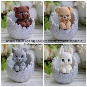 May include: Four silicone moulds for making fondant or resin animal babies in eggshells. The moulds are shown with finished animal babies in the eggshells. The animals are a bear, a dog, a cat, and a rabbit.