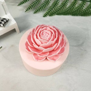 May include: A pink silicone mold shaped like a large rose flower. The mold is perfect for making soap, candles, or other crafts.
