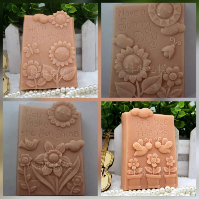 May include: Four rectangular soap molds with raised designs. The molds feature a sunflower, a butterfly, a bird, and a bee. The molds are made of a light brown silicone material. The text on the molds reads: "Hello Sunshine!", "Have a Sunny Day", "You make the Sun Shine", and "Let's bee friends..."