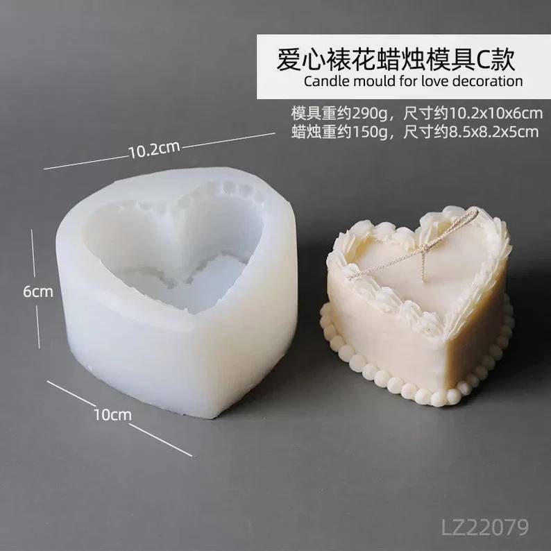 May include: A white silicone heart-shaped candle mold with a finished candle in the background. The finished candle is a heart-shaped cake with white frosting and pearl accents. The mold is 10.2 inches wide and 6 inches tall. The finished candle is 8.5 inches wide and 5 inches tall.  "爱心裱花蜡烛模具C款 Candle mould for love decoration 模具重约290g, 尺寸约10.2x10x6cm 蜡烛重约150g, 尺寸约8.5x8.2x5cm LZ22079"