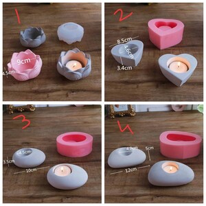 May include: Four silicone molds for making concrete candle holders. The molds are in the shapes of a flower, a heart, and two different oval shapes. The molds are pink and clear. The finished candle holders are shown in gray concrete.