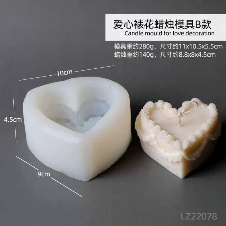 May include: Two heart-shaped silicone molds for making candles. The larger mold is 11 inches by 10.5 inches by 5.5 inches and weighs 280 grams. The smaller mold is 8.8 inches by 8 inches by 4.5 inches and weighs 140 grams. The text "爱心裱花蜡烛模具B款 Candle mould for love decoration" is visible in the image.