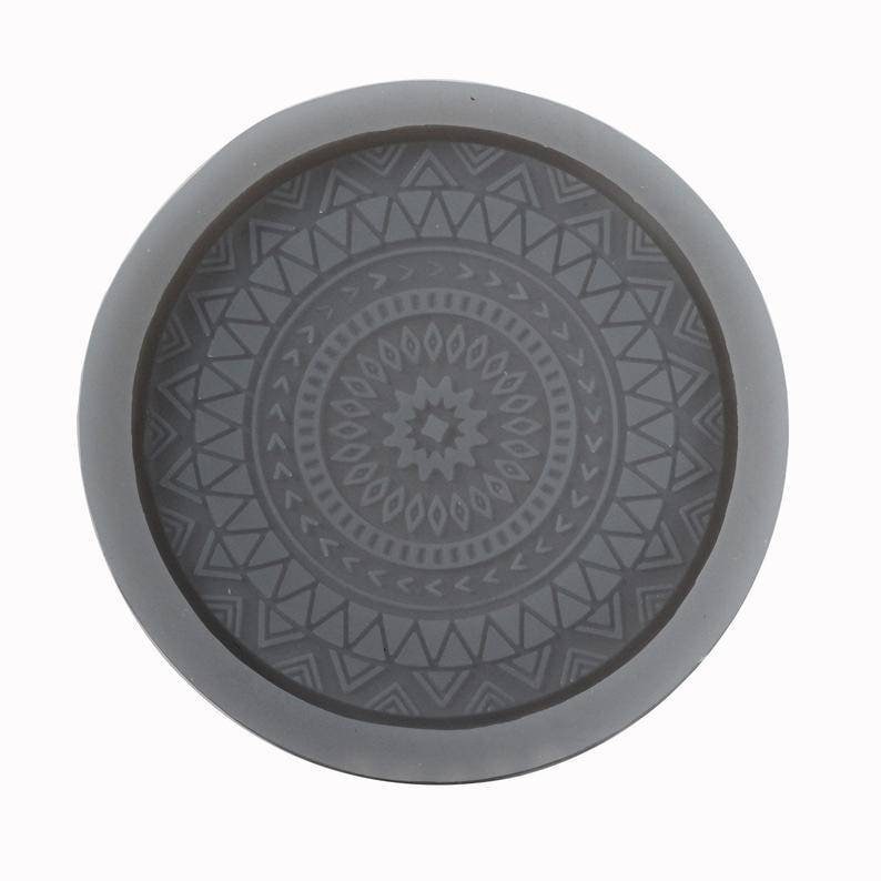 May include: Grey silicone mould with a circular design featuring a geometric pattern. The mould is perfect for creating resin coasters or other decorative items.