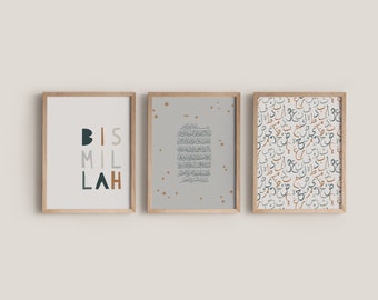 May include: Three framed art prints with a light wood finish. The left print has the word "BISMILLAH" in teal, brown, and gray. The center print has Arabic script on a gray background with gold stars. The right print has a pattern of Arabic script.
