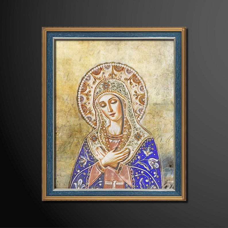 May include: A framed painting of a woman in a blue robe with a crown of flowers on her head. She is looking down with her hands clasped in prayer.
