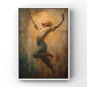 May include: A framed art print depicts a person mid-leap with arms raised. The figure is dressed in a light-colored shirt and blue pants, set against a textured, painterly background with a golden sun-like circle. The artwork is framed in a white border.