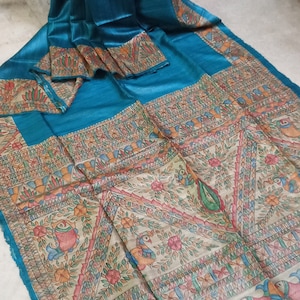 Madhubani paint Madhubani art drawn on pure Ghicha Tassaur saree in teal blue shed comes with running Blouse piece.. (Silk mark certified)