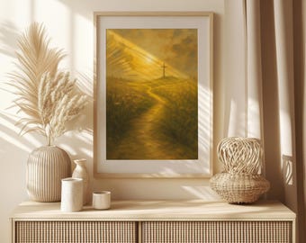 Könnte beinhalten: Gerahmtes Kunstwerk, das einen Weg zu einem Kreuz auf einem Hügel zeigt, der von goldenem Sonnenlicht durchflutet wird. Das Gemälde befindet sich in einem Holzrahmen und wird auf einem hellen Schrank ausgestellt. Dekorative Vase und Pampasgras sind links.