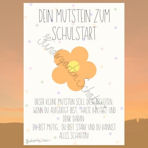 May include: A white rectangular card featuring a central orange flower graphic and scattered pastel dots. The text reads: DEIN MUTSTEIN ZUM SCHULSTART. DIESER KLEINE MUTSTEIN SOLL DICH BEGLEITEN. WENN DU AUFGEREGT BIST, HALTE IHN FEST UND DENK DARAN: DU BIST MUTIG, DU BIST STARK UND DU KANNST ALLES SCHAFFEN! Kindergarten Schatz.