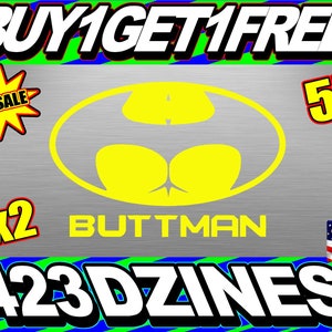 May include: A yellow silhouette of a superhero logo with the text "BUTTMAN" in yellow letters. The logo is on a silver background with the text "BUY1GET1FREE" at the top, "X2" at the bottom left, and "5" at the top right. The text "423 DZINES" is at the bottom center. The text "made in the USA" is at the bottom right.