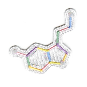 May include: White embroidered patch with a colorful chemical structure, resembling a molecule. The patch is made of white fabric with colorful thread embroidery.
