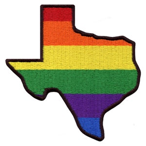 May include: An embroidered patch in the shape of the state of Texas, with the colors of the rainbow flag. The patch is red, orange, yellow, green, purple, and blue.