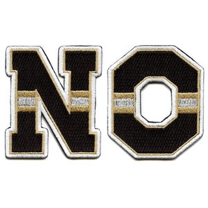 May include: Embroidered patches spelling "NO". The letters are black with gold and white accents. The "N" is a standard block letter, while the "O" is a stylized octagon shape.