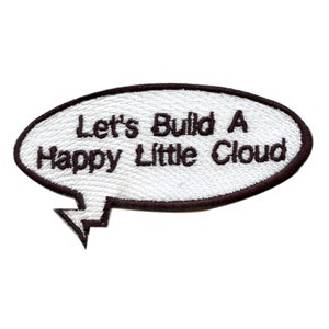 May include: White embroidered patch with a brown outline in the shape of a speech bubble. The text inside the speech bubble reads "Let's Build A Happy Little Cloud".