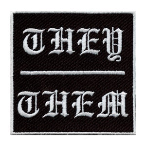 May include: Black embroidered patch with white text that reads "THEY THEM" in a gothic font.