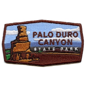 May include: Embroidered patch featuring a brown rock formation with a blue sky and white clouds. The text "PALO DURO CANYON STATE PARK" is embroidered in white on a brown background.