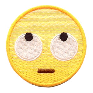 May include: Embroidered yellow patch featuring a surprised emoji face. The emoji has large white eyes with black pupils looking upwards, a small brown mouth, and a yellow border. The patch is round and has a textured appearance.