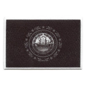 May include: Black and white embroidered patch featuring the state seal of Tennessee. The seal depicts a ship with three masts and a white star above it, surrounded by a wreath of leaves.