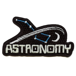 May include: Black embroidered patch with white text that reads "ASTRONOMY". The patch features a white and blue constellation design with a crescent moon.