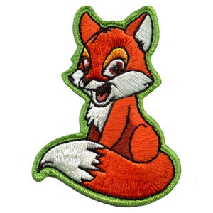 May include: An embroidered patch of a cartoon fox with a green outline. The fox is orange with a white chest and a white tip on its tail.