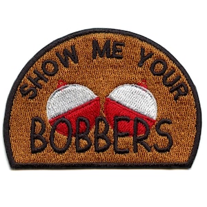 May include: Embroidered patch with the text "SHOW ME YOUR BOBBERS" in black lettering. The patch features two red and white bobbers on a brown background, with a black border. A fun accessory for fishing enthusiasts.