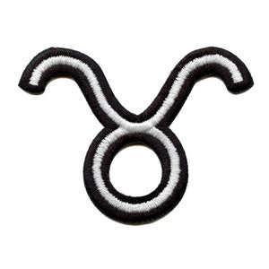 May include: Black and white embroidered iron-on patch of the Taurus zodiac sign.
