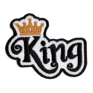 May include: Black and white embroidered patch with the word "King" in a stylized font. A gold crown sits above the word.